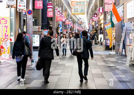 Kyoto, Japan - April 17, 2019: Many people business salaryman walking in suit in Nishiki market shops for lunch Stock Photo