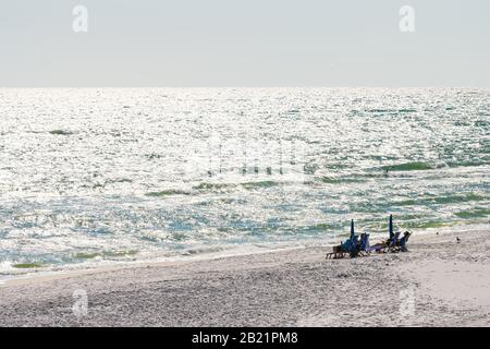 Seaside, USA - April 25, 2018: Resort beach during sunny bright day in Florida town village with high angle view of people on shore and waves horizon Stock Photo