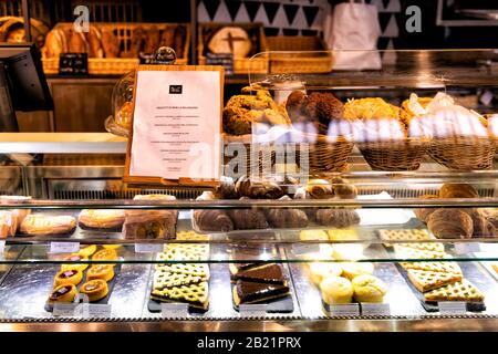 Florence, Italy - August 30, 2018: Interior of Firenze Centrale Mercato central market with glass counter display of food in bakery and menu Stock Photo