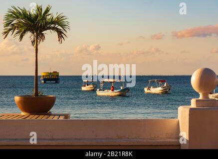 Cozumel, Quintana Roo, Mexico - February 4, 2019: View of the boardwalk and the sea with a lot of boats in Cozumel at sunset Stock Photo