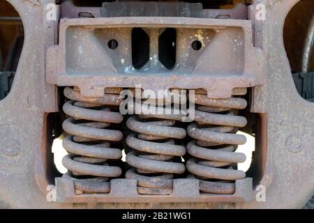 Large coil springs on the undercarriage of a train car. Closeup view. Stock Photo