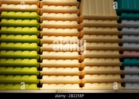 A lot of rectangular colorful flower pots close-up. Nested. The garden was taken at the market. Stock Photo