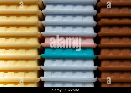 A lot of rectangular colorful flower pots close-up. Nested. The garden was taken at the market. Stock Photo