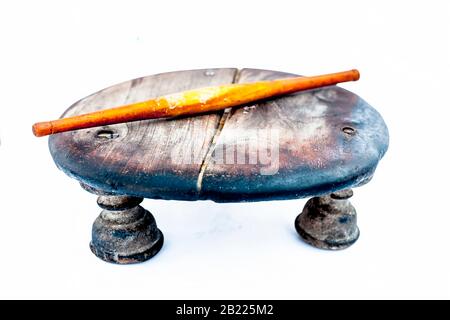 Close up of old vintage wooden rolling pin and circular board isolated on white used to make Phulka/chapati/roti. Stock Photo