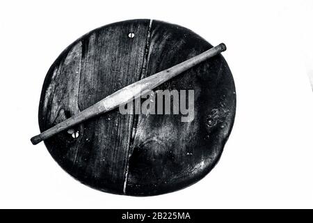 Close up of old vintage wooden rolling pin and circular board isolated on white used to make Phulka/chapati/roti. Stock Photo