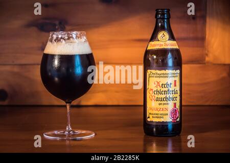 Bamberg, Germany - February 23 2020: Dark Bamberg Smoked Beer from the famous Schlenkerla Brewery in Bamberg, Bavaria, Germany in the Glass with its B Stock Photo