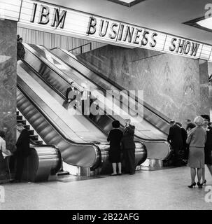 Escalators to the main exhibition area of the IBM Business Show at the New York Coliseum on Columbus Circle in Manhattan, New York City, circa April 30, 1963. Stock Photo