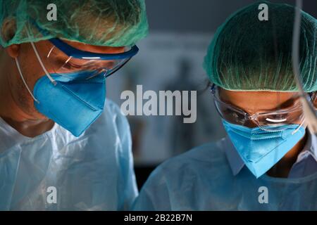 Surgeon and anastasiologist in uniform look down Stock Photo