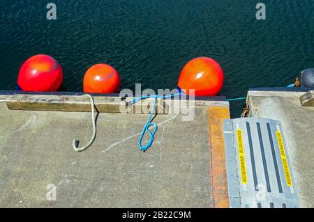 Orange buoys on a dock in Prince Rupert, British Columbia, Canada Stock Photo