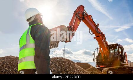 ecivil engineer foreman worker on construction site with excavator Stock Photo