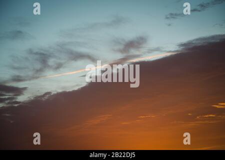 Orange burning clouds on a morning sunrise cloudscape sky Stock Photo