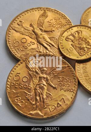 golden coins, 50 pesos mexicans and 10 florins Stock Photo