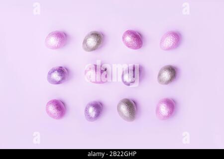Colored painted pearl chicken and quail eggs of pink, silver, golden color Stock Photo