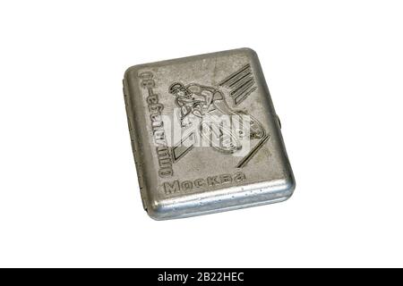 Aluminum cigarette case with Olympic symbols and the image of a cyclist on a white background, close-up shot. Stock Photo