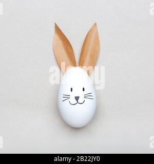 Happy easter minimal concept, egg with happy bunny rabbit face Stock Photo
