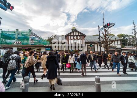 TOKYO, JAPAN - FEB 2019 : Undefined people and tourist crowd visiting and walking on the street cross-walk at Harajuku station on Febuary 16, 2019, Ja Stock Photo