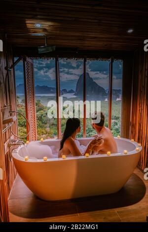 sunset in bathtub in the bathroom during vacation in Thailand watching sunset over the ocean and moutnains Phangnga Bay Thailand Stock Photo