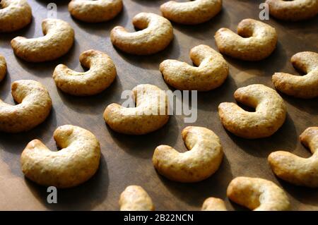 Tasty walnut cookies close-up on a baking sheet. horizontal view from above. Fresh baked. Recipe photo for cooking book. Stock Photo