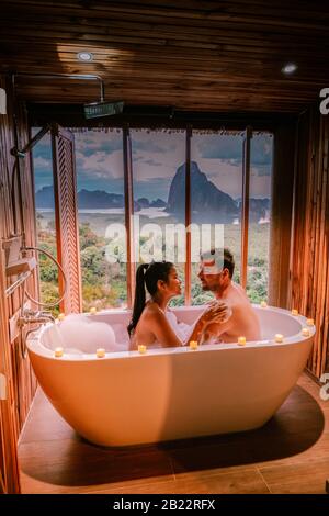 sunset in bathtub in the bathroom during vacation in Thailand watching sunset over the ocean and moutnains Phangnga Bay Thailand Stock Photo