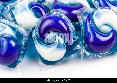 A pile of washing dishwasher or laundry blue white chemical detergent pods, packs, pouches closeup macro detail. Household items, objects concept, set Stock Photo