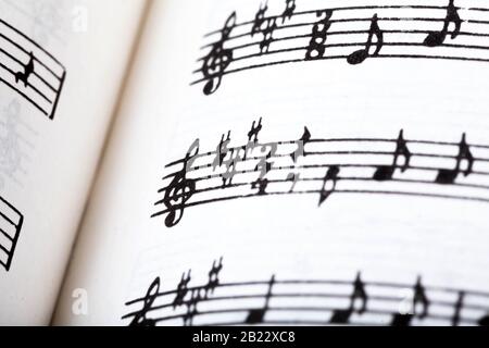 Key signature symbol and violin clef. Musical notation macro, closeup. Single line sheet music detail example, playing an instrument, learning theory Stock Photo