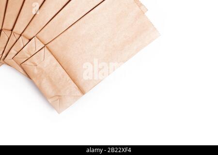 A few simple small tiny eco friendly new disposable brown paper bags set background Saving the environment by using an ecological paper food packaging Stock Photo