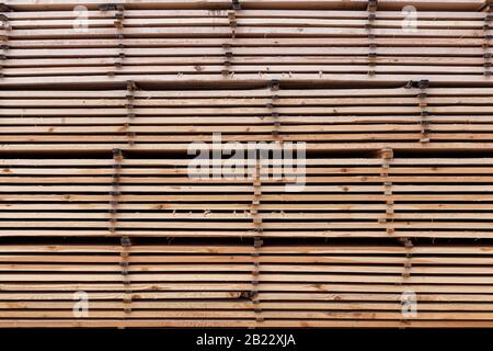 large stacks of wooden planks full frame flat background Stock Photo