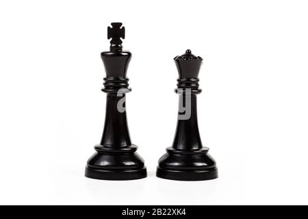 King and queen, two simple chess figures isolated on white, cut out. Royal couple, royalty abstract concept, pair of game pieces, chess symbol, power Stock Photo