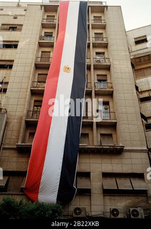 Travel Photography - The Egyptian Flag flies from a building in Central Downtown Cairo in Egypt in North Africa Middle East Stock Photo