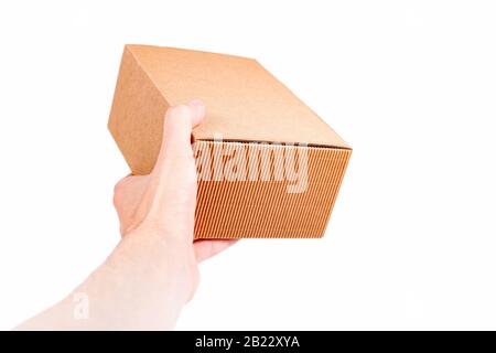 Man handing a small brown closed cardboard package, quick shipment delivery, transportation and product shipping concept first person view Carton box Stock Photo