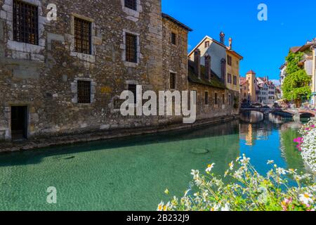The River Thiou and the side of the medieval Le Palais de l'Ile viewed from Quai de l'Ile, Annecy, France, on a bright September day Stock Photo