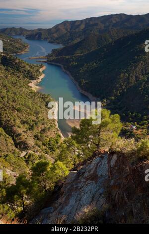 The Rio Verde valley near Istan in Andalusia, with the Embalse de la Concepcion lake and North Africa in the background Stock Photo