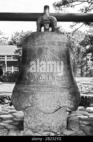 Black and white detail view of a large metal bell near St. Marie the Virgin Episcopal Church in Sagada Town, Mountain Province, Luzon, Philippines Stock Photo