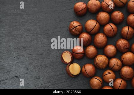 Macadami nut close-up on a black stone background Stock Photo
