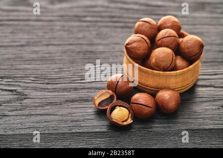 Macadam nut close-up on a black wooden background Stock Photo