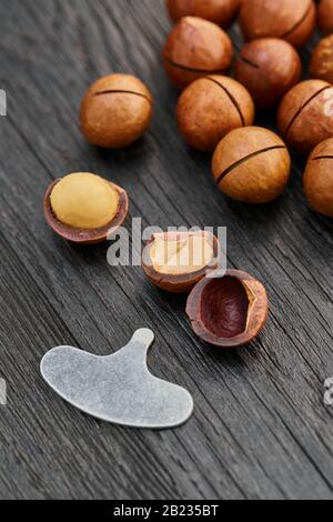 Macadam nut close-up on a black wooden background Stock Photo