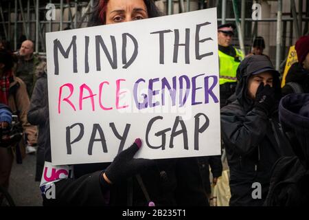 26th February 2020 - Mind the Race Gender Pay Gap.  Protestors march through the City of London by St Paul's Cathedral on the 'March for Education', Stock Photo