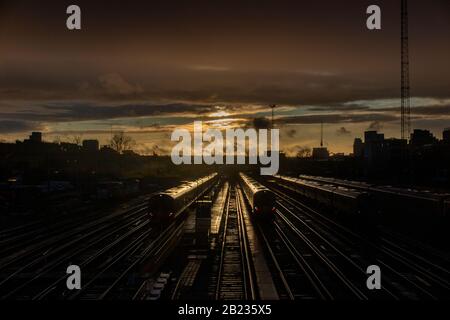 A winter sunset and two trains approach Clapham Junction Stock Photo