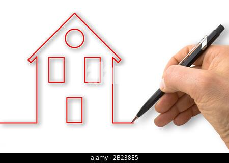 A hand draws the outline of a red house - concept image Stock Photo