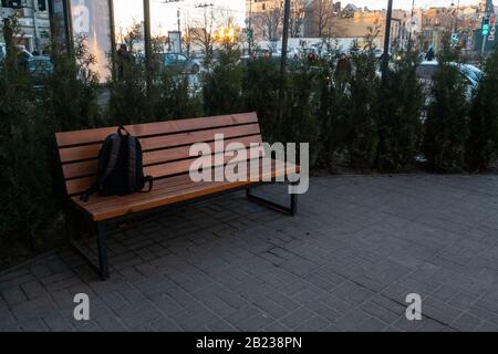 A lost backpack lying on a park bench. Stock Photo