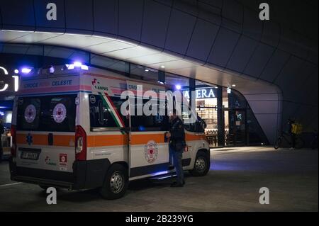 Milan, Italy. 26th Feb, 2020. An ambulance parked outside the CityLife Shopping District amid Coronavirus fears.According to the regional decree affirming the closure of shops in shopping malls for the COVID-19 emergency, and the cancellation of Milan's carnival activities, only restaurants, supermarkets and pharmacies will be open during the weekend (29th February and 1st March 2020) in the entire prestigious CityLife Shopping District Mall in Milan. Credit: SOPA Images Limited/Alamy Live News Stock Photo
