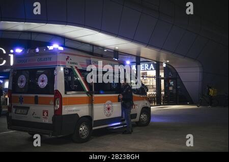 Milan, Italy. 26th Feb, 2020. An ambulance parked outside the CityLife Shopping District amid Coronavirus fears.According to the regional decree affirming the closure of shops in shopping malls for the COVID-19 emergency, and the cancellation of Milan's carnival activities, only restaurants, supermarkets and pharmacies will be open during the weekend (29th February and 1st March 2020) in the entire prestigious CityLife Shopping District Mall in Milan. Credit: Valeria Ferraro/SOPA Images/ZUMA Wire/Alamy Live News Stock Photo