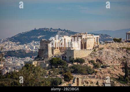 Athens, Greece. Acropolis propylaea propylea or propylaia entrance gateway and monument Agrippa pedestal, view from Philopappos Hill. Stock Photo