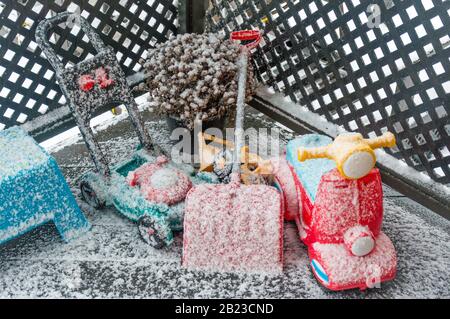 Toys under snow in winter Stock Photo