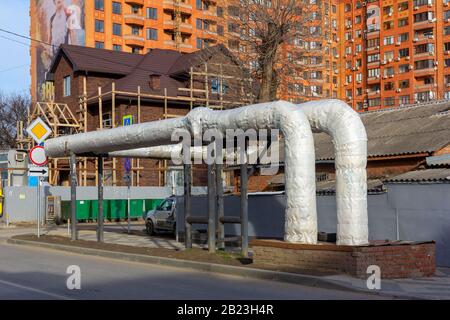 Krasnodar, Russia - February 11, 2020: Overhead heat pipes. A pipeline above ground that conducts heat for heating urban homes Stock Photo