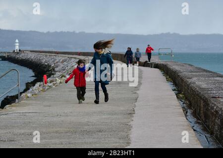 Brixham, Devon, UK. 29th Feb 2020. UK Weather.Storm Jorge lashes Brixham  in Devon,people seen running along the Breakwater to avoid the aproaching Storm Jorge. Picture Credit Robert Timoney/Alamy/Live/News Stock Photo