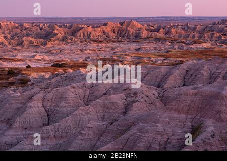 SD00252-00...SOUTH DAKOTA - Sunset painting the buttes orange along the Sage Creek Rim Road in Badlands National Park. Stock Photo