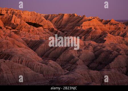 SD00254-00...SOUTH DAKOTA - Sunset painting the buttes orange along the Sage Creek Rim Road in Badlands National Park. Stock Photo