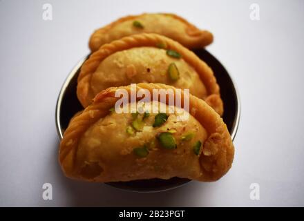 Tasty Indian Sweet dish Chandrakala meaning Half moon is deep fried Dumpling eaten during Holi festival Stock Photo