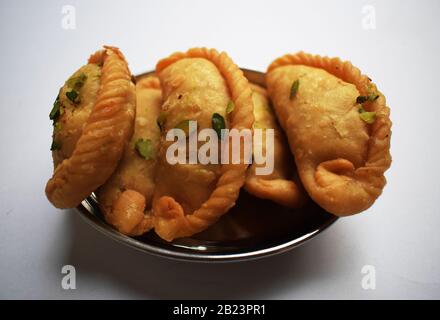 Tasty Indian Sweet dish Chandrakala meaning Half moon is deep fried Dumpling eaten during Holi festival Stock Photo